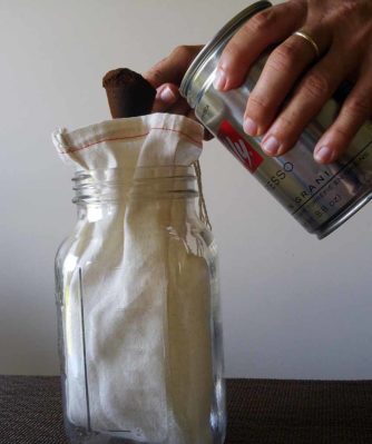 Dumping coffee grounds in coffee brewing bag